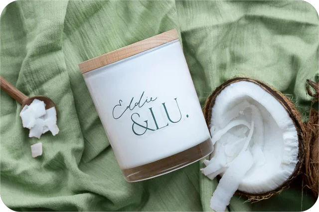 EL cocowax candle, coconut & lime with fresh open raw coconut + measure-of-coconut-wooden-sp 
on.