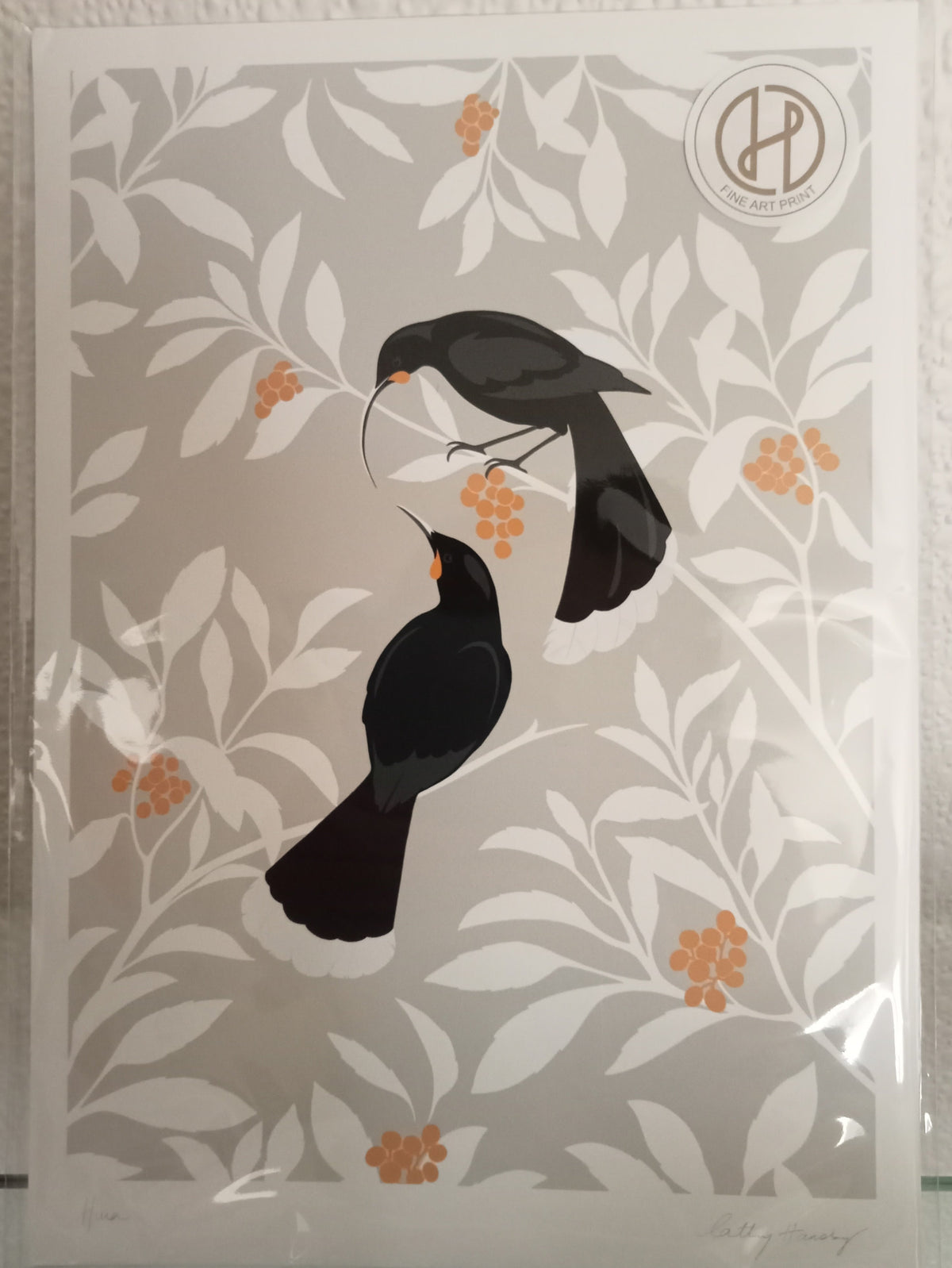 Decorative card with black Huia birds on a floral Koromiko pattern