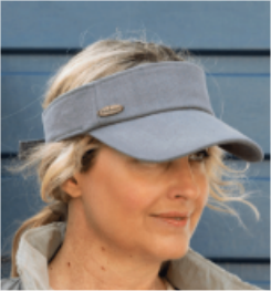 Lady wearing a washed denim blue visor, against a blue background