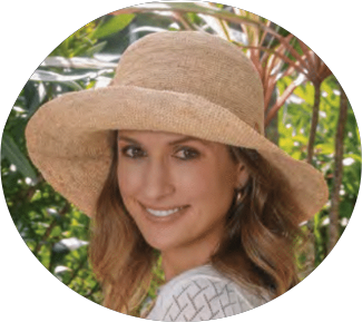Woman wearing a wide-brimmed straw hat with a natural background